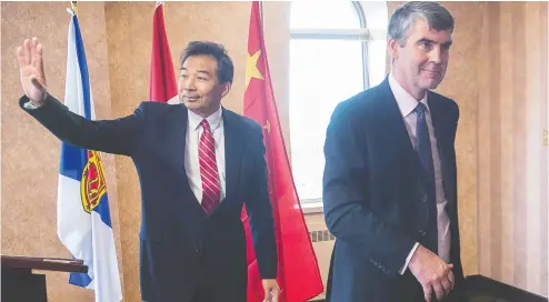  ?? Andrew VAUGHAN / THE CANADIAN PRESS FILES ?? Luo Zhaohui, China’s then-ambassador to Canada, waves as he and Nova Scotia
Premier Stephen Mcneil head from a meeting in 2016.