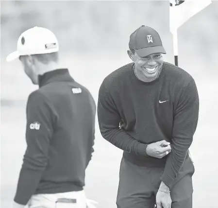  ?? IAN RUTHERFORD/USA TODAY SPORTS ?? Tiger Woods laughs with Justin Thomas during a practice round at Carnoustie on Monday.