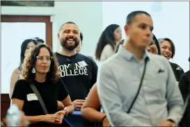  ?? ?? Visitors listed to Pomona Arts Colony co-founder Ed Tessier tell stories during the opening ceremony of Pomona College Community Center in Pomona on Saturday.