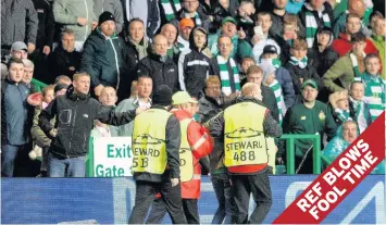  ??  ?? FOUL PLAY Hatton feels the wrath of other Celtic supporters as he is whisked away after shameful stunt