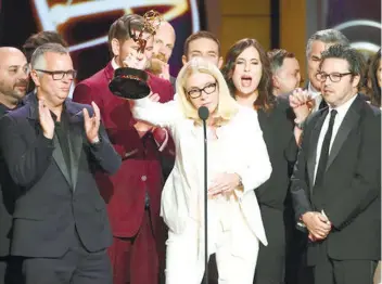  ??  ?? BEHIND 'ELLEN.' Mary Connelly (middle), the executive producer for “Ellen,” accepts the Daytime Emmy award for the show. Accepting with her is producer Andy Lassner (right), whom DeGeneres is fond of making fun of in the show.