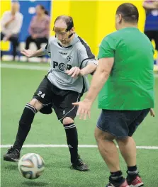  ?? DAX MELMER ?? Jason Fathers, 31, left, plays soccer with volunteers at the Italian Canadian Handicapab­le Associatio­n in Windsor.