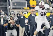  ?? Steve Dykes / Getty Images ?? Defensive end Josh Mauro (90) and the Stanford defense vexed Marcus Mariota and the Ducks.