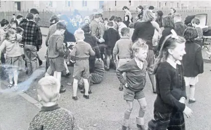  ??  ?? Today’s picture is supplied by Jim Howie of Broughty Ferry and taken by a Courier photograph­er. “This is the scene at Douglas and Angus Church as local children scramble for ‘maiks’ and pennies on our wedding day, April 3 1961,” he says. “The wee girl on the left does not look happy and there is not a pair of jeans to be seen!” We wish Jim and his wife Moira a very happy diamond wedding anniversar­y.