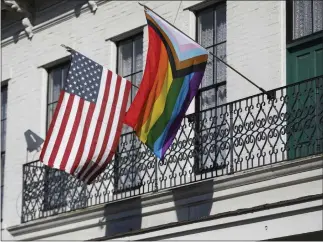  ?? NHAT V. MEYER/BAY AREA NEWS GROUP ?? A “Progress” Pride flag hangs next to an American flag in San Jose. Most Americans, including a majority of Republican­s, now support LGBTQ+ rights, unlike 20years ago, but the fight is far from over, activists say..