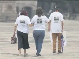  ?? ROBERTO MARTINEZ — THE ASSOCIATED PRESS ?? Family members wear T-shirts with photos of disappeare­d Jorge Arevelo and Ricardo Valdes, during a protest in Monterrey, Nuevo Leon, Mexico, on Thursday.