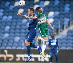 ?? ( Maor Elkaslasi) ?? MACCABI HAIFA and Hapoel Beersheba ( in blue) battled in front of empty stands at Sammy Ofer Stadium on Sunday night, with the Greens emerging with a 3- 1 home victory in Israel Premier League Round 2 action.