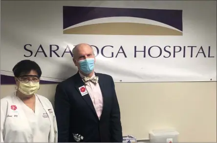  ?? PHOTO PROVIDED ?? Saratoga Hospital employees Carol Howard, RN and Dr. Michael Holland, director of Occupation­al Medicine at Saratoga Hospital, wear #IGotTheSho­t stickers.