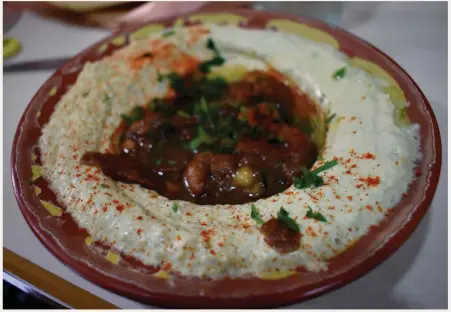  ??  ?? HUMMUS, Palestinia­n style, at Abu Shukri restaurant (63 Hagai Street).