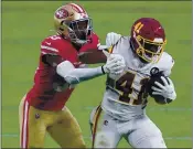  ??  ?? Washington Football Team running back J.D. McKissic (41) is tackled by San Francisco 49ers defensive back Tarvarius Moore (33) during the second half Sunday in Glendale, Ariz.