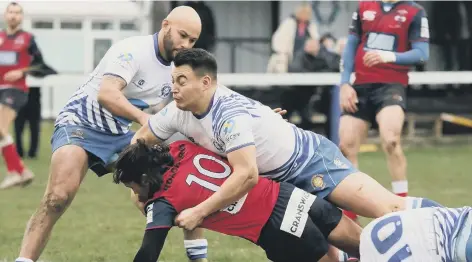  ?? PICTURE: MICK SUTTERBY ?? Kaz Henderson makes a smother tackle on a Hull Ionians player on his return to the Lions side after injury.