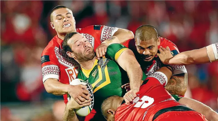  ?? GETTY IMAGES ?? Australian captain Boyd Cordner is tackled by Tuimoala Lolohea and Sika Manu of Tonga during last night’s test at Mt Smart Stadium in Auckland.