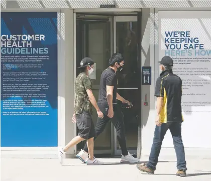  ?? BRANDON HARDER ?? Shoppers wearing masks enter Regina’s Cornwall Centre Mall on Sunday. Retail stores are among the locations allowed to resume physical operations as part of the province’s reopening plan but it will likely be a few more weeks before more businesses are given the green light.