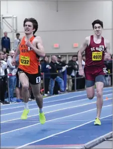  ?? PHOTO BY JIM MAHONEY — MEDIANEWS GROUP/BOSTON HERALD ?? Newton North’s Tyler Tubman, left, kicked past BC High’s Christophe­r Larnard to win the boys mile race at the Reggie Lewis Center on Friday.