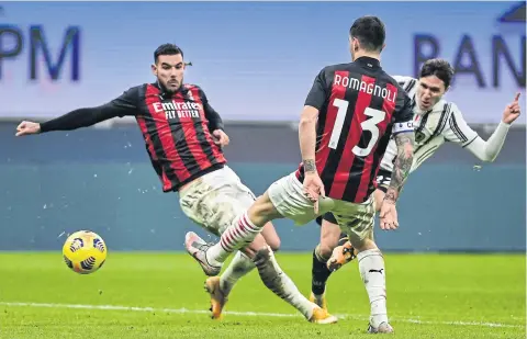  ?? AFP ?? Juventus forward Federico Chiesa, right, shoots to score his second goal against AC Milan at the San Siro stadium.