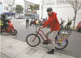  ?? Liz Hafalia / The Chronicle ?? Stephen Rodriguez, vice president of growth at San Francisco startup Scoot, shows an e-bike that the company plans to rent in Barcelona, Spain.