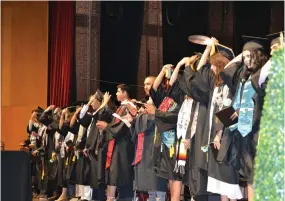  ?? ?? The Harmony Magnet Academy Class of 2023 turn their tassels during the graduation on Friday at the Buck Shaffer Theater at Portervill­e Memorial Auditorium.