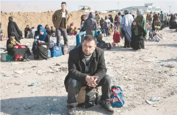  ?? — AFP ?? A displaced Iraqi man, who fled the violence in the IS group stronghold of Mosul, waits for transporta­tion to IDP camps near the town of Bartella on Saturday during a military operation by Iraqi security forces against IS militants.