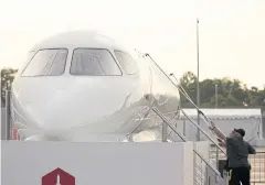 ??  ?? Workers clean a mock-up Dassault Aviation Falcon 6X private jet displayed during the Singapore Airshow in February.