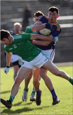  ??  ?? Podge O’Toole tussles with Limerick’s Sean McSweeney.