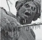  ?? ?? Icicles hang from the Angelina Eberly statue in downtown Austin, Texas, on Wednesday. School systems in the Dallas and Austin area, plus many in Oklahoma, Arkansas and Memphis, Tennessee, closed Thursday as snow, sleet and freezing rain continued to push through.