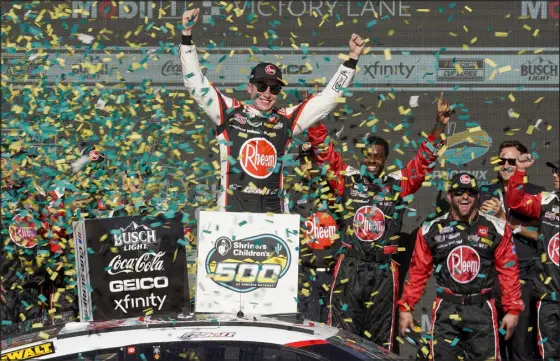  ?? DARRYL WEBB — THE ASSOCIATED PRESS ?? Christophe­r Bell, center, celebrates after his NASCAR Cup Series win at Phoenix Raceway on Sunday in Avondale, Ariz.