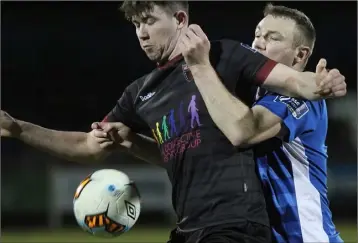  ??  ?? Wexford F.C. attacker Craig Hayes shields the ball from Kenny Browne of Waterford.