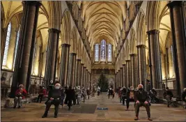  ?? FRANK AUGSTEIN — THE ASSOCIATED PRESS ?? People sit and relax after receiving their Pfizer-BioNTech vaccinatio­n at Salisbury Cathedral in Salisbury, England, Wednesday. Salisbury Cathedral opened its doors for the second time as a venue for the Sarum South Primary Care Network COVID-19Local Vaccinatio­n Service.