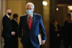  ?? ASSOCIATED PRESS ?? SENATE MAJORITY LEADER MITCH MCCONNELL of Ky., wears a face mask to protect against the spread of the new coronaviru­s as he walks to the Senate chamber after meeting with Vice President Mike Pence and Treasury Secretary Steve Mnuchin on Capitol Hill in Washington on Tuesday.