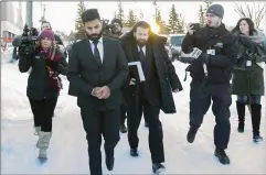  ?? CP PHOTO KAYLE NEIS ?? Jaskirat Singh Sidhu leaves provincial court with his lawyer Mark Brayford (centre right) in Melfort, Sask. Sidhu, the driver of a transport truck involved in a deadly crash with the Humboldt Broncos junior hockey team’s bus, has pleaded guilty to all charges against him.