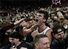  ?? Charles Krupa/Associated Press ?? Boston College forward Quinten Post celebrates with fans after the Eagles defeated No. 6 Virginia, 63-48, in Boston.