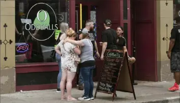  ?? Emily Matthews/Post-Gazette ?? People stand outside Oddballs on East Carson Street on Saturday on the South Side.