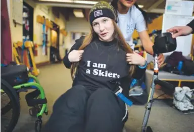  ??  ?? Kailyn Forsberg flaunts her shirt Saturday, her first day back on the snow since being paralyzed in a slopestyle skiing accident last year. AAron Ontiveroz, The Denver Post