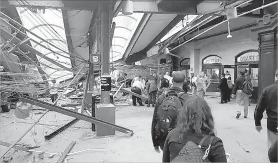  ?? Ian Samuel Associated Press ?? UPON ITS arrival at Hoboken Terminal, a commuter train launched onto the platform and caused a ceiling to collapse, killing a woman who was standing below.