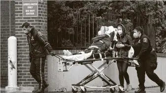  ?? Mark Lennihan / Associated Press ?? A patient is moved in New York on Wednesday. The majority of people newly hospitaliz­ed with the virus in New York are either retired or unemployed and were avoiding public transit.