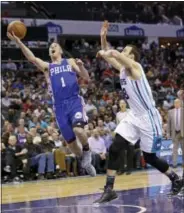  ?? THE ASSOCIATED PRESS ?? Philadelph­ia 76ers’ TJ McConnell (1) drives past Charlotte Hornets’ Miles Plumlee (18) in the second half of an NBA game in Charlotte, N.C. on Monday. The 76ers won 105-99.