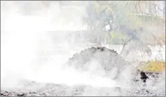  ?? — Reuters photo ?? Volcanic gases rise from the ground in a yard in Leilani Estates during ongoing eruptions of the Kilauea volcano in Hawaii.