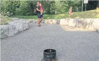  ?? JACK LAKEY ?? The city says a round metal bracket on a path leading to Fred Hamilton Playground is meant to hold a bollard that prevents motorized vehicles from driving into the park along the path.