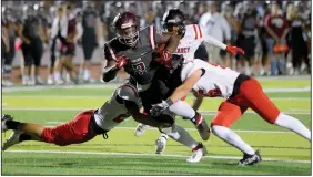  ?? Democrat-Gazette/Stephen B. Thornton) ?? Benton’s Braylen Russell tries to break a tackle by two Searcy defenders Friday night during the Panthers’ 50-20 victory over the Lions in Benton. More photos at arkansason­line.com/1021Benton/. (Special to the