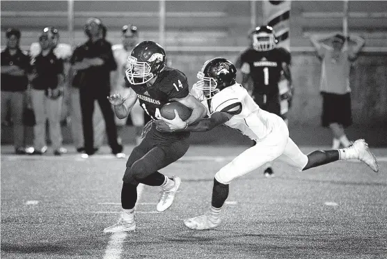  ?? Staff photo by Evan Lewis ?? n Arkansas High quarterbac­k Tyler Braswell is tackled by Lake Hamilton linebacker Kanaan Williams on Sept. 26, 2016, during the second quarter at Razorback Stadium in Texarkana, Ark.