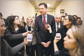  ?? Chip Somodevill­a / Getty Images ?? Former FBI Director James Comey is surrounded by reporters after testifying to the House Judiciary and Oversight and Government Reform committees at the Rayburn House Office Building on Capitol Hill on Friday in Washington.