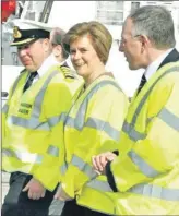  ?? ?? 2013: A happy Nicola Sturgeon in Campbeltow­n with harbour master Stephen Scally, left, and Sandy Mactaggart, Argyll and Bute Council’s executive director of developmen­t and infrastruc­ture.