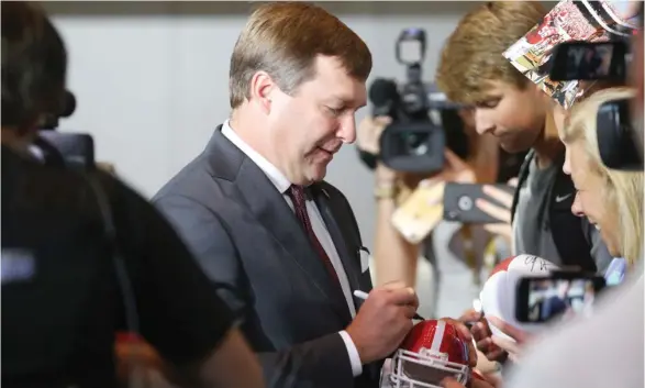  ?? (Photo by Joshua L. Jones, Athens Banner-Herald, AP) ?? Georgia coach Kirby Smart signs autographs for fans at the SEC Football Media Days in Atlanta on Tuesday.