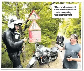  ??  ?? Officers help a group of bikers after one of them crashes, requiring hospital treatment