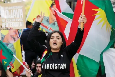  ??  ?? A Kurdish protester waves a flag during a demonstrat­ion against Turkey’s military action in northeaste­rn Syria in Zurich, Switzerlan­d on Saturday. REUTERS