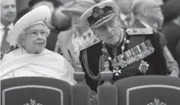  ?? JOHN STILLWELL/AP ?? Queen Elizabeth II and her husband Prince Philip watch the proceeding­s from the royal barge on London’s Thames River during Diamond Jubilee Pageant Sunday.