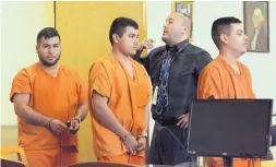  ?? GREG SORBER/JOURNAL ?? Double-murder suspects Eder Ortiz-Parra, left, Rafael Gonzalez-Parra, center, and Edwin Edsel Ortiz-Parra walk into District Court past bailiff Dominic Sandoval for their first appearance on Wednesday.