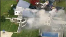  ?? WABC VIA AP ?? In this image made from a video provided by WABC firefighte­rs battle a fatal fire on Tuesday in Colts Neck.
