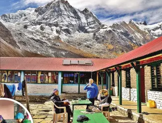  ?? ?? Tea at the ABC guesthouse with Annapurna South in the background; Eating breakfast in Deorali (inset)