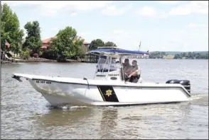  ?? The Sentinel-Record/Richard Rasmussen ?? ON PATROL: Garland County Sheriff’s Department Marine Patrol Deputy Richard Huffman, left, and Cpl. Scott Hinojosa patrol Lake Hamilton Friday.